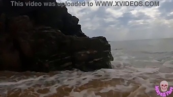 A Steamy Encounter Between A Pair On A Beach In View Of Others
