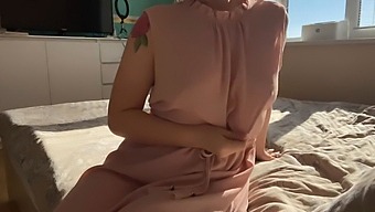 A Dainty Woman In A Pink Dress Explores Her Intimate Areas